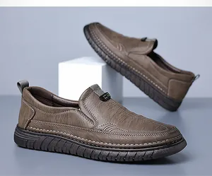 Close-up of brown slip-on leather shoes with elastic straps and textured rubber sole
