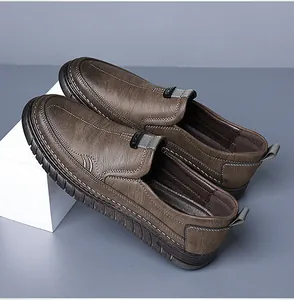 Detail view of brown leather loafer featuring contrast stitching and durable rubber sole