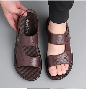Detail of dark brown leather beach sandals with adjustable straps and non-slip footbed