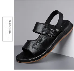 Detail of premium black pebble grain leather sandal with silver buckle and studs