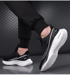 Detail view of breathable black mesh sneakers with thick white soles on a male model