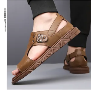 Detail view of men's brown leather sandals with crocodile texture and metal chain