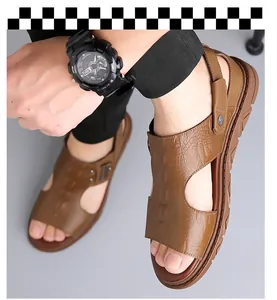 Close-up of brown leather sandals for men featuring crocodile pattern and metal rivet details