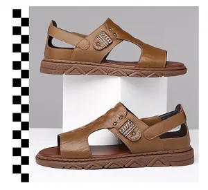 Close-up of brown leather sandals featuring embossed crocodile texture and metal buckle detail