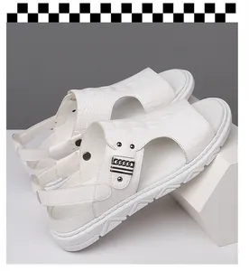 Detailed macro view of white leather men's sandals with embossed crocodile pattern and chain