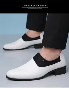 Close-up of men's business loafers featuring white and black leather with a metal buckle