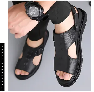 Detail of black crocodile texture leather and convertible heel strap on men's beach sandals