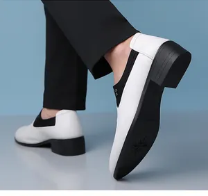 Detail of men's two-tone leather loafers showing white vamp and black heel contrast