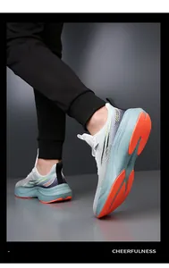 Detail view of the cushioned thick sole and non-slip orange grip of the running shoe