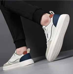 Detail showing white casual sneakers with navy blue heel and thick non-slip rubber sole