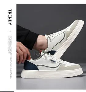 Detail of trendy white leather sneakers featuring gray suede toe and navy heel accents