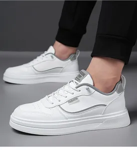 Detail view of white leather sneakers featuring breathable perforations and gray accents