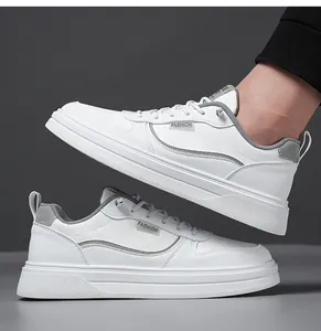Detailed side view of white casual sneakers featuring grey fashion label and thick soles
