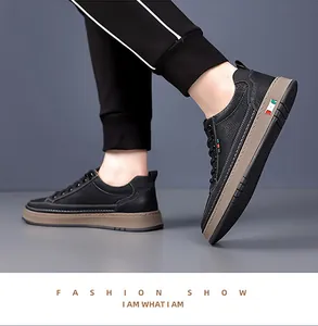 Detail view of men's black leather casual shoes showing litchi texture and tri-color flag deco