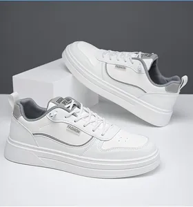Detail view of men's white casual sneakers with grey fashion accents and anti-slip sole