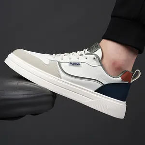Men's white low-top casual sneakers with color-block stitching and non-slip rubber sole