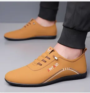 Close-up of ginger yellow men's casual shoes featuring side embroidery and rubber sole