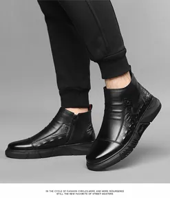 Detail view of men's black high-top leather boots with side zipper and crocodile texture
