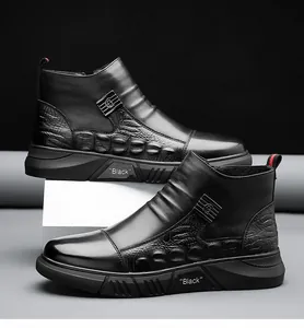Detail of high-top men's black leather boot with crocodile texture and metal buckle