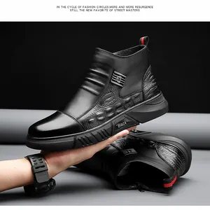 Detail view of black men's boots featuring crocodile pattern and branded buckle