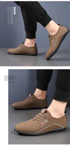 Detail view of brown leather casual men's loafers showing non-slip rubber soles and stitching