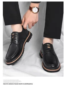 Detail of classic black pebbled leather texture and thick rubber sole with brown welt