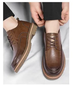 Macro detail of brown leather lace-up brogue shoes with thick rubber soles on gray fabric