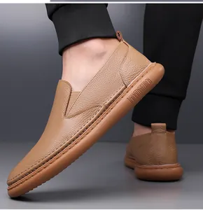 Macro detail of men's brown pebbled leather loafers with durable soles and stitching
