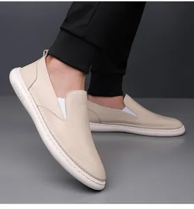 Close-up of beige leather loafers featuring soft grain texture and comfortable thick white sole