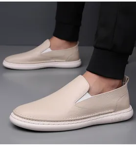 Macro detail of beige loafers showing pebbled leather texture and white elastic strap