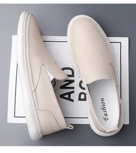Detail view of cream leather loafers featuring lychee texture and soft rubber soles