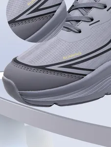 Detail of grey running shoe with mesh texture and yellow running text on a blue background