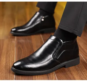 Detailed view of men's business leather boots with side zipper and polished black finish