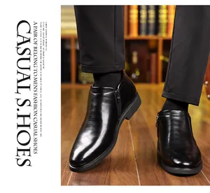 Detail of men's black business leather boots with side zipper and elegant toe stitching