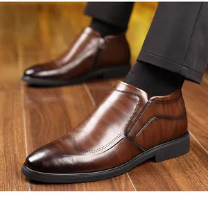 Detail view of men's dark brown leather dress boots with side zipper and wood-grain texture