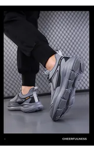 Detail view of thick anti-slip sole and SPORT lettering on grey mesh running sneakers