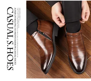 Detail of brown leather business boots with side zipper and brogue decorative stitching