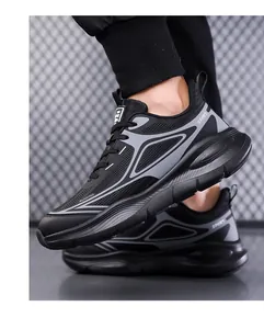 Close-up of black breathable mesh running shoes with SPORT print on metallic background