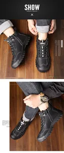 Detail of men's black high-top winter boots with side zipper and white stitching