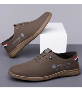 Detail view of brown leather slip-on shoes with 'Fu' character and striped ribbon accents