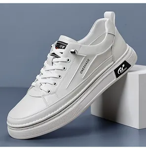 Detail shot of white synthetic leather casual sneaker showing side branding and lace-up design