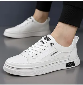 Close-up of white fashion sneakers featuring ONESHADE lettering and soft leather texture