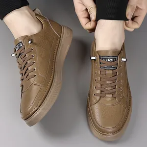 Men's brown textured leather sneakers with rubber sole and lace-up design in a studio setting