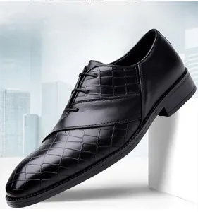 Detail of men's formal black leather shoes with embossed crocodile texture and laces