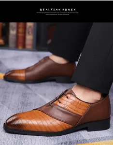 Detail of men's dark brown business shoes with smooth leather and crocodile embossing