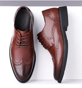 Macro view of caramel brown leather brogue shoes with classic wingtip wing stitching details
