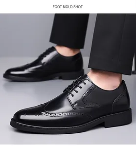 Detail of black Brogue dress shoes with classic wingtip punching and waxed round laces