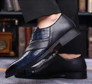 Detail showing the pointed toe and crocodile pattern embossing of the leather business shoe