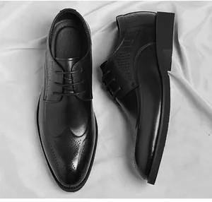 Detail of black leather brogue shoes with crocodile texture and elegant lace-up design
