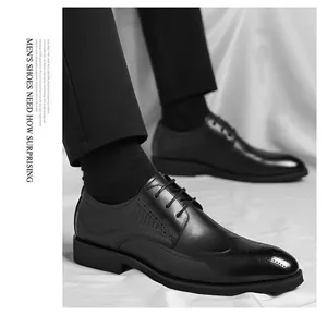 Detail of black men's brogue dress shoes with crocodile texture and classic lace-up style